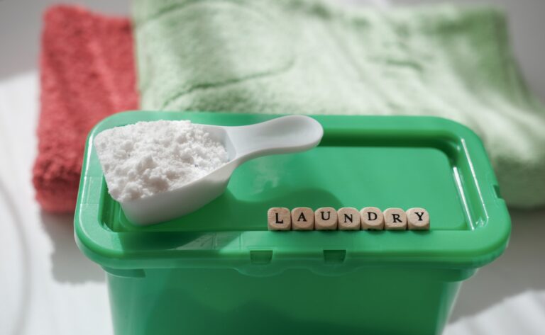 laundry word on dice. washing powder or detergent in a scoop.